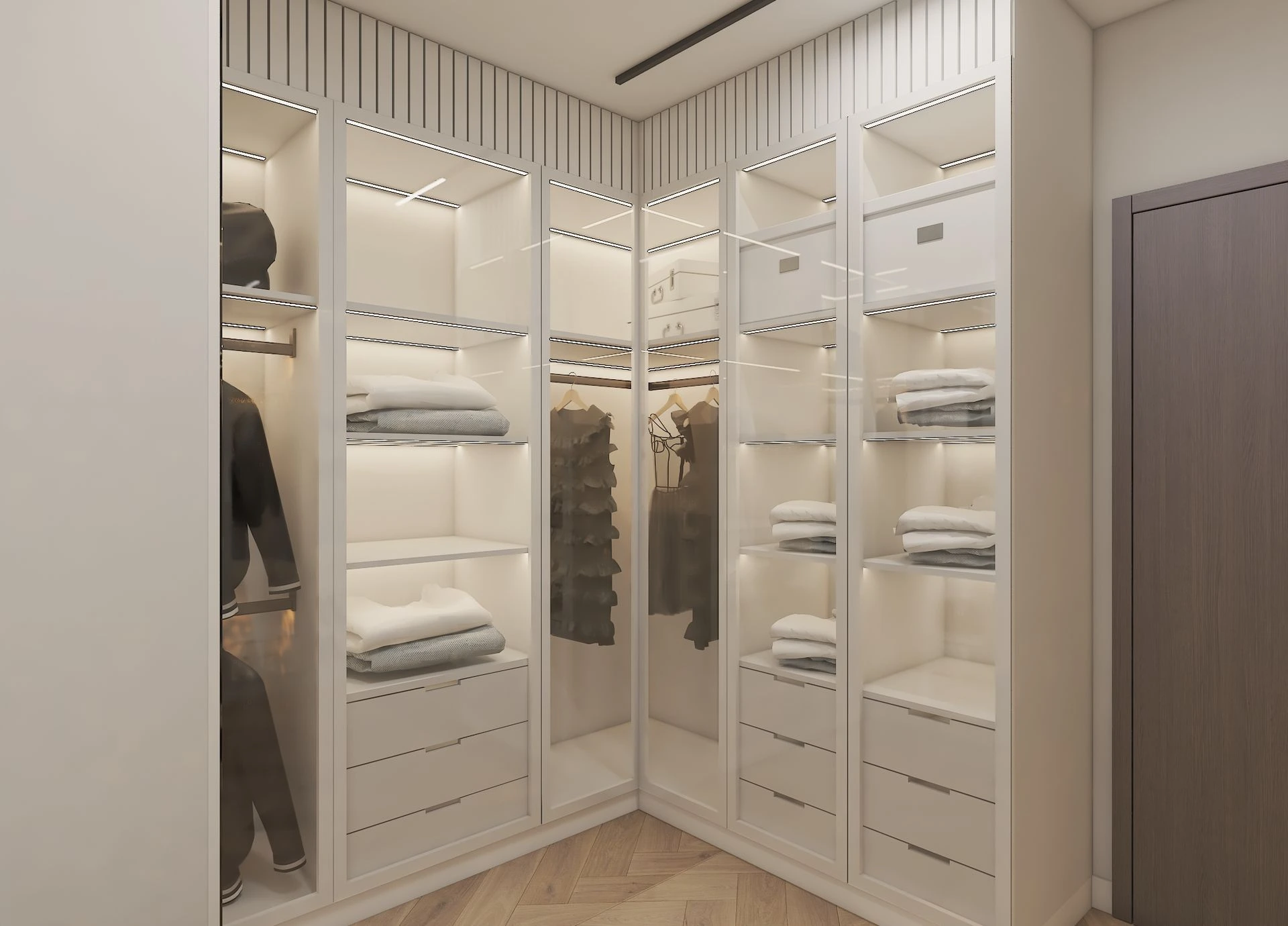 Glass-fronted wardrobes with lit shelves and shoe displays in a walk-in dressing room, Dubai